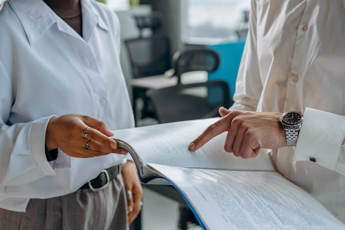 two professionals discussing a contract