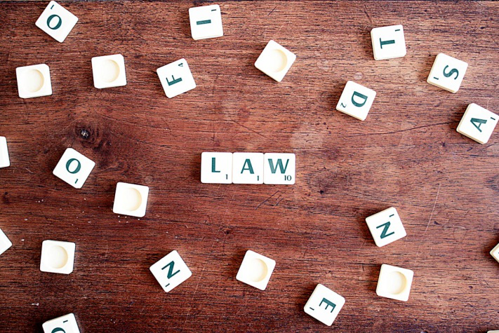 The word “Law” spelt with scrabble tiles