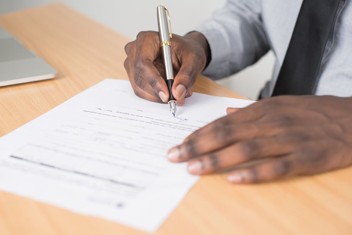 a person is signing a contract