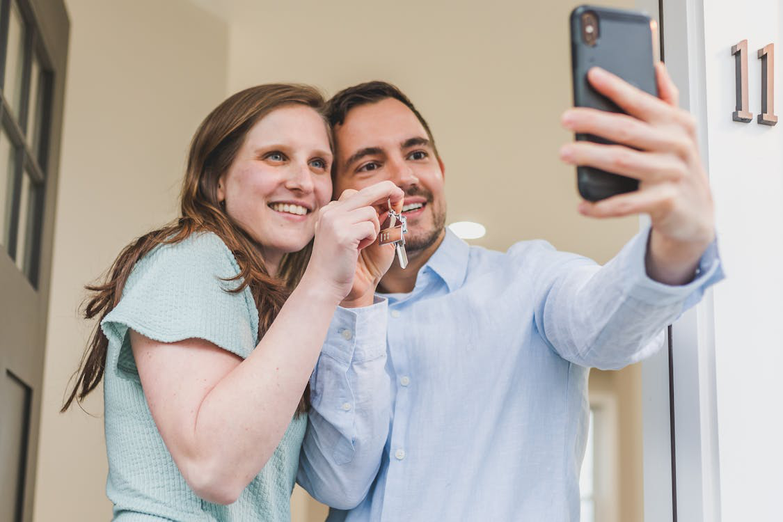 A Couple Take a Selfie with Their New House Keys