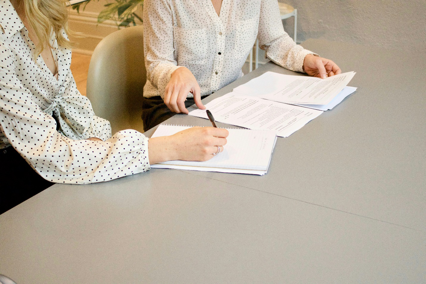 Two women studying documents 