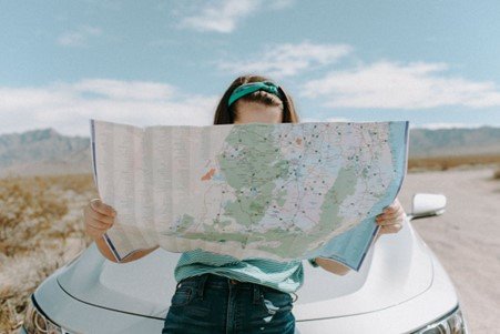 A person holding a large map