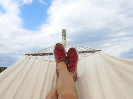 A person’s legs on a hammock