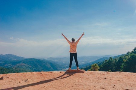 A person celebrating with their arms raised in victory