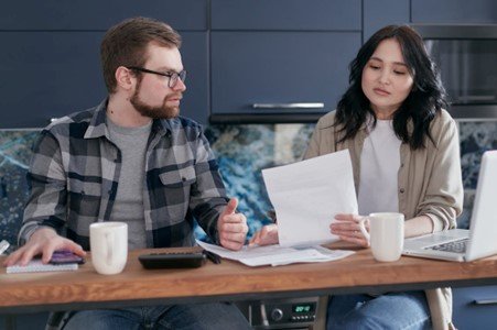 A couple looking stressed while viewing a legal document