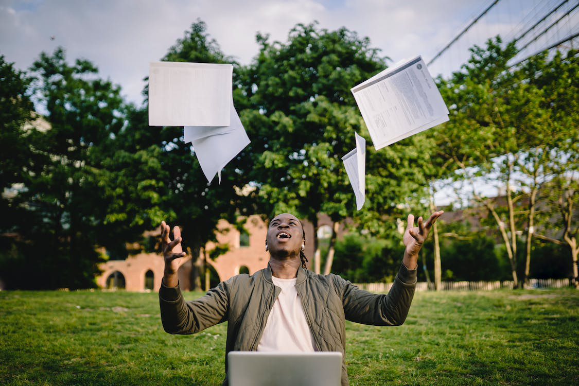 A person throwing documents up in the air