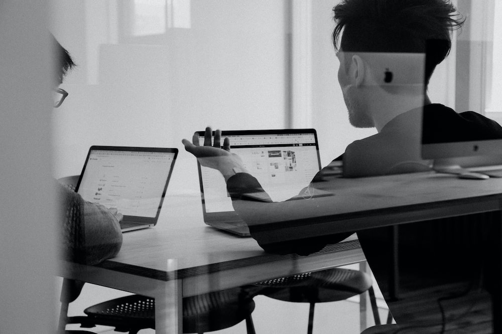 Two people working on their laptops