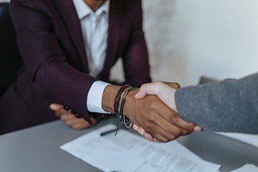 Person shaking hands with a lawyer, symbolizing legal support in timeshare contract termination